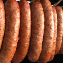 Load image into Gallery viewer, rich coloured smoke sausages hanging from stainless steel rods